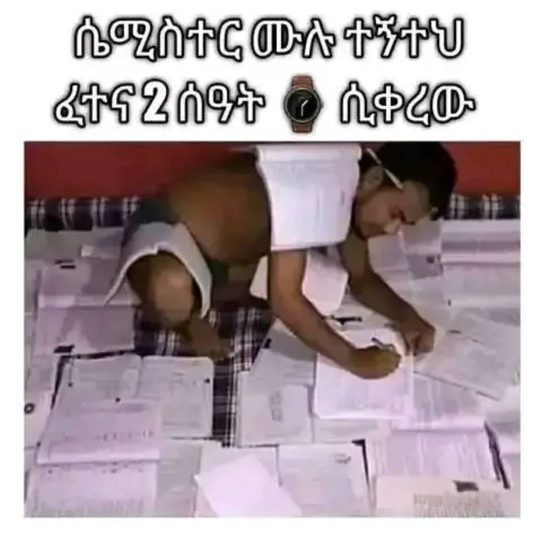 a man is writing on paper with a pen